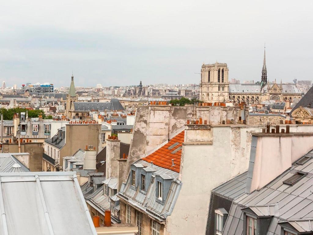 a view of the city from the roofs of buildings at Hotel le Lapin Blanc in Paris