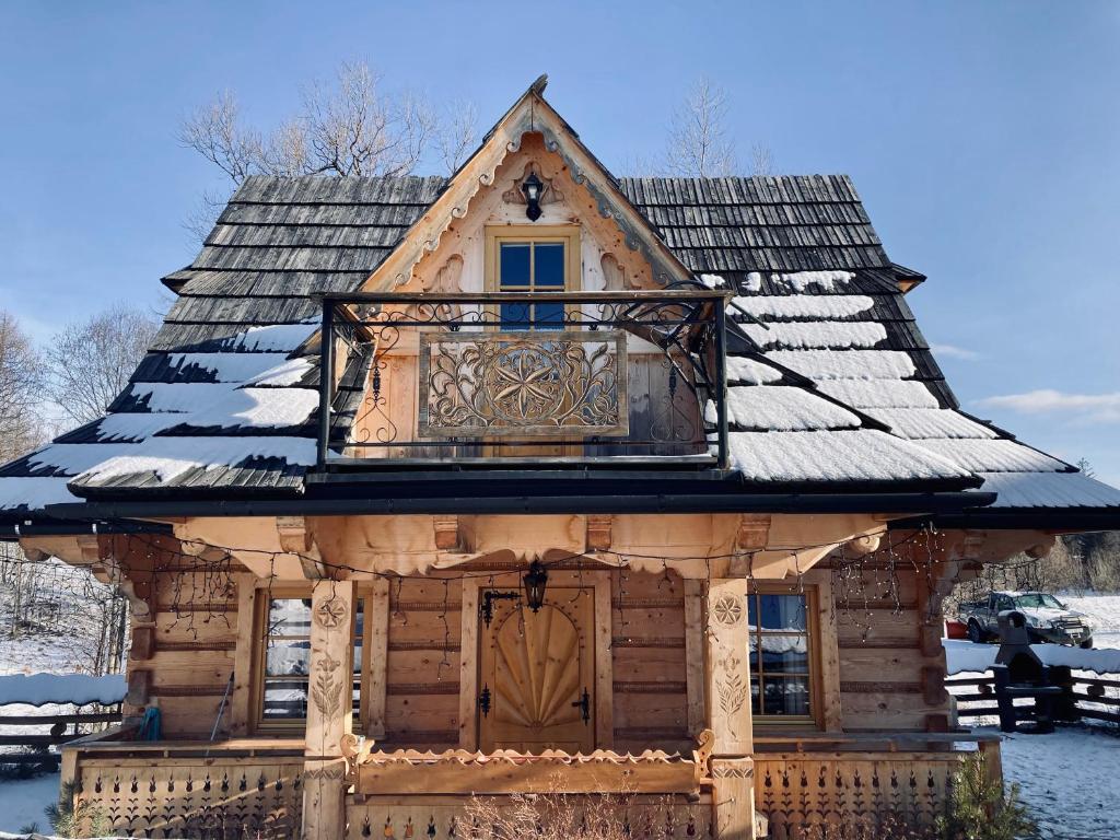 a log cabin with a roof in the snow at Domek Góralski- Highlander Chalet Kościelisko-Zakopane in Kościelisko