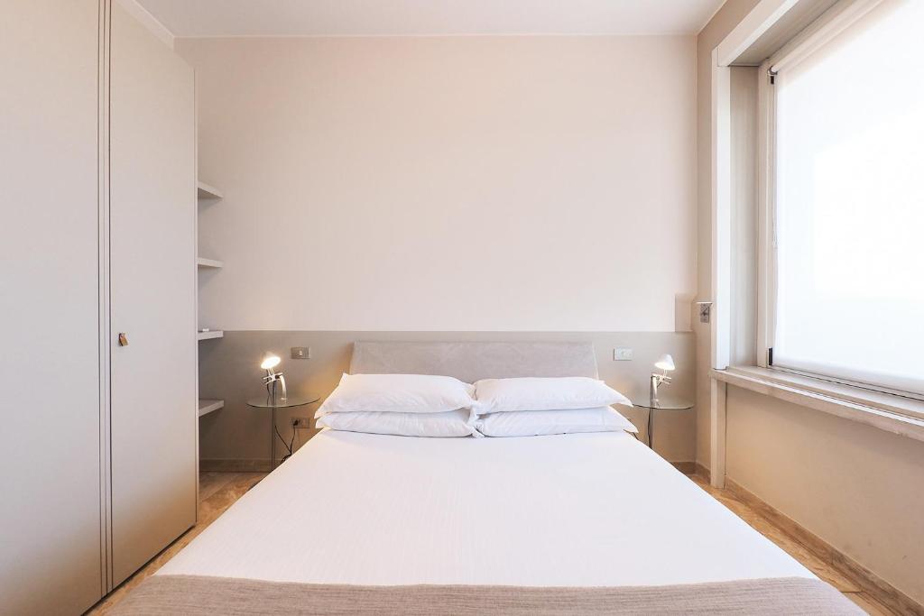Łóżko lub łóżka w pokoju w obiekcie Contempora Apartments - Elvezia 8 - E52