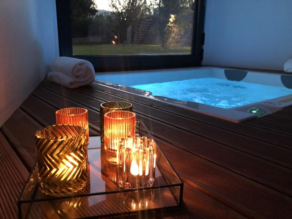 a jacuzzi tub with candles on a table at Portovella Lodges & Bungalows in Pala