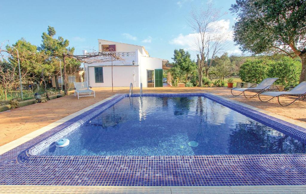 a swimming pool in the backyard of a house at Nice Home In Algaida With 2 Bedrooms And Outdoor Swimming Pool in Algaida