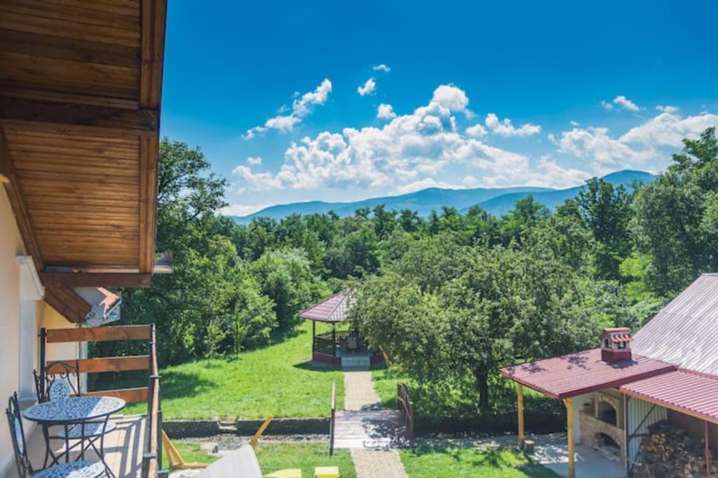 a balcony with a view of the mountains at Horace Guesthouse POOL & HOT TUB & BIKES & RIVER in Dejani