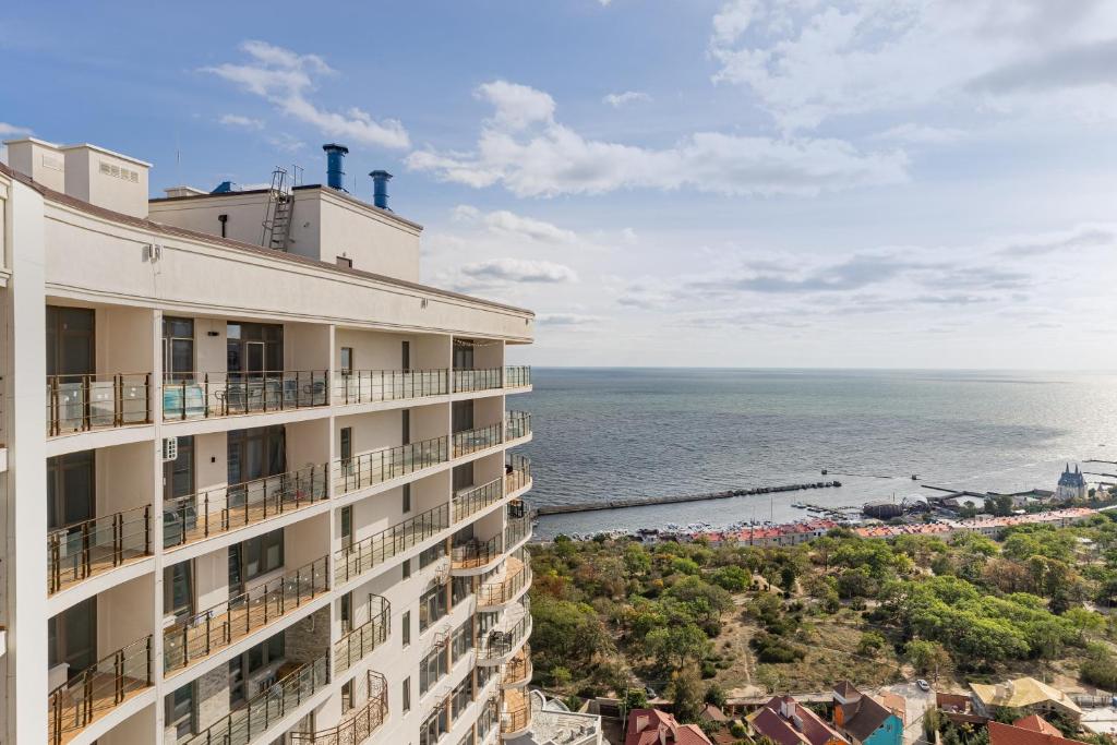 a view of the ocean from the balcony of a building at Pearl 44 Apartment With Terrace in Odesa