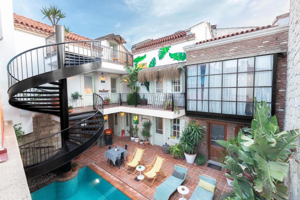 an apartment building with a spiral staircase and a pool at Hotel Pop Alaçatı in Alaçatı