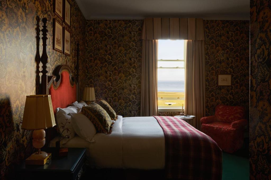 a bedroom with a bed and a window with a view at Marine North Berwick in North Berwick