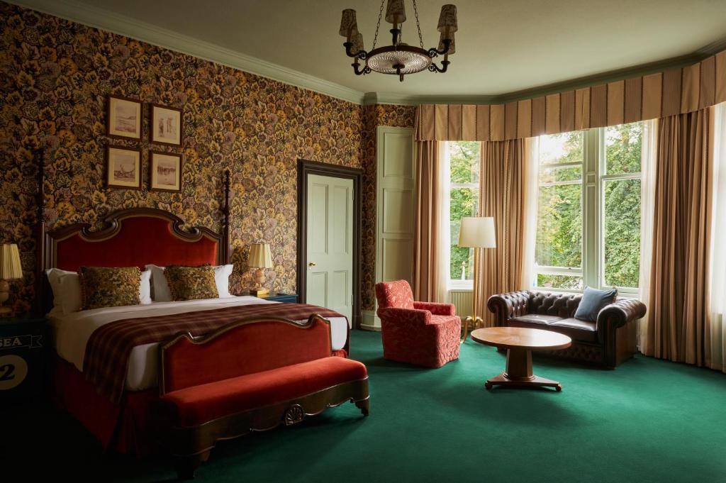 a bedroom with a bed and a chair and a table at Marine North Berwick in North Berwick