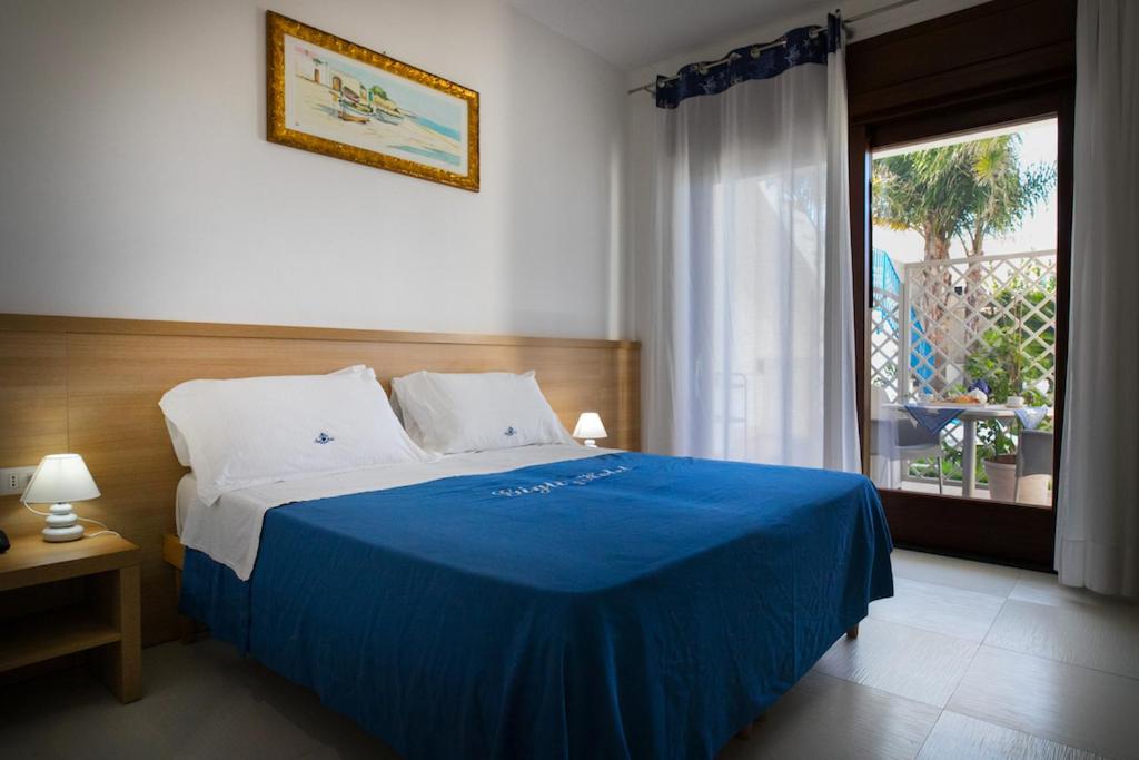 Postel nebo postele na pokoji v ubytování Gigli Hotel Salento