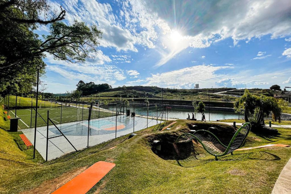 a playground in a park with a pool of water at Container ABOBORA na natureza da Serra Gaúcha in Flores da Cunha