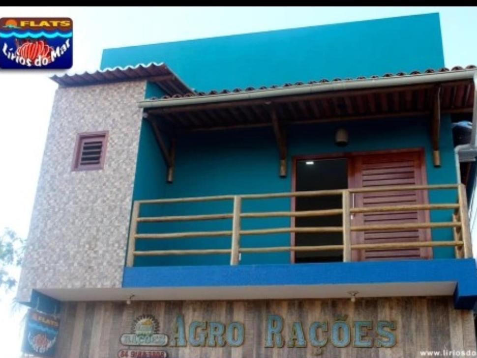 a blue and white building with a balcony at Flats Lírios do Mar in São Miguel do Gostoso