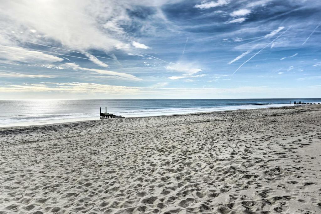 a beach with footprints in the sand and the ocean at Bright Condo Half-Block to Cape May Beach! in Cape May