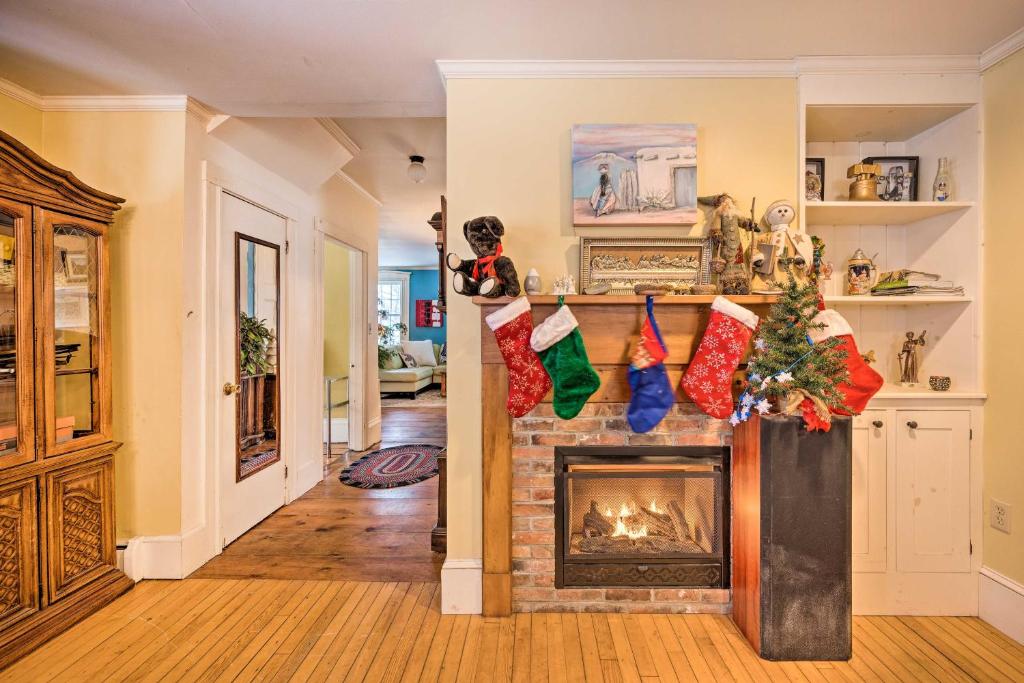 a living room with a fireplace with christmas ornaments at Vintage Farmhouse Near Sunday River Ski Slopes! in Rumford