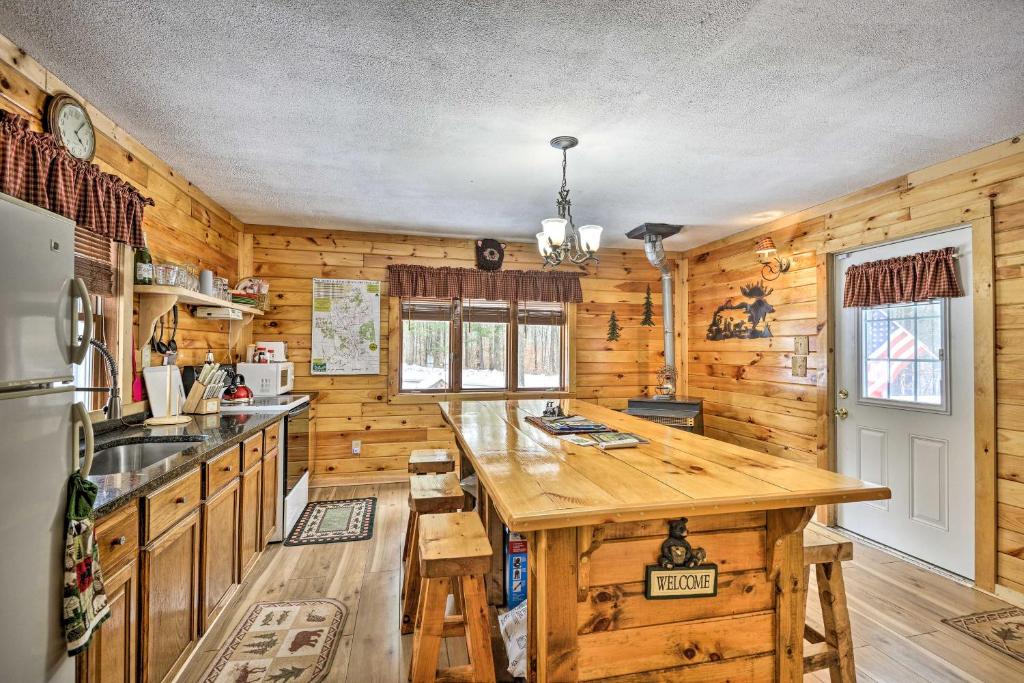 a kitchen with wooden walls and a large wooden island at Pet-Friendly Brantingham Cabin by ATV Trails in Glenfield