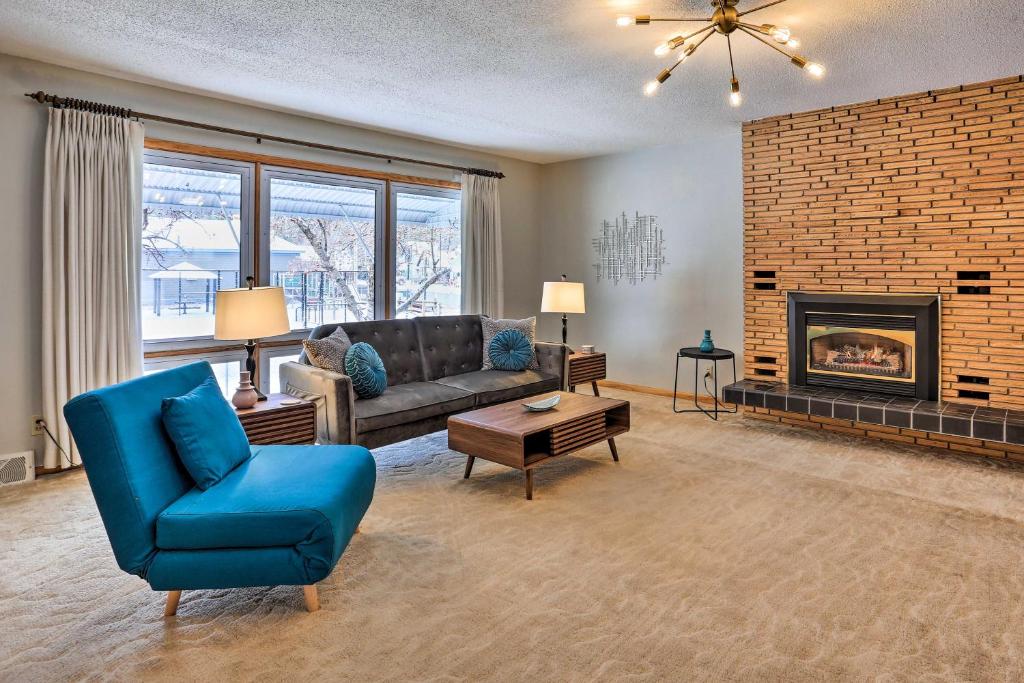a living room with a couch and a fireplace at Deadwood Apartment - Walk to Historic Downtown! in Deadwood