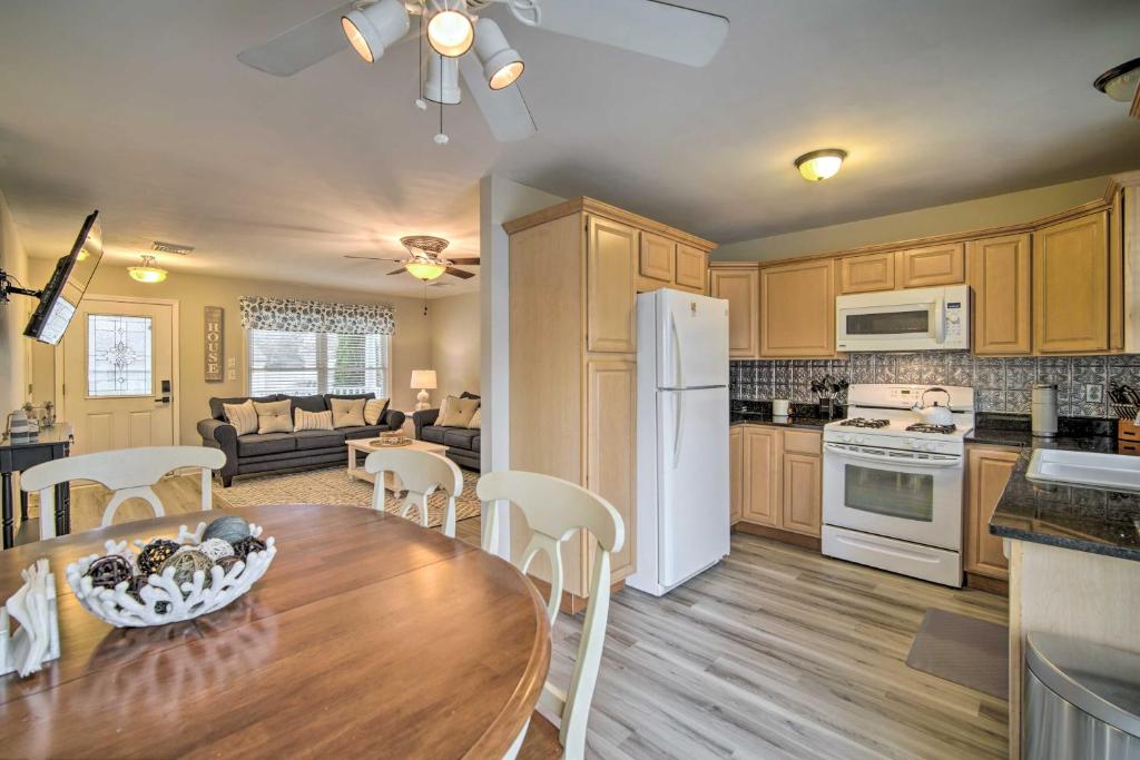 a kitchen and living room with a table and chairs at Charming Somers Point House with Private Pool! in Somers Point