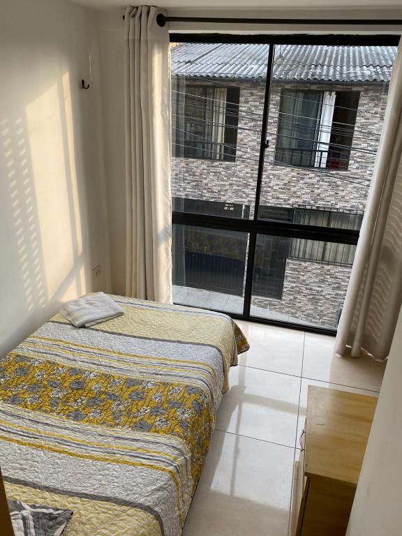 Una cama o camas en una habitación de Luxury Hostal