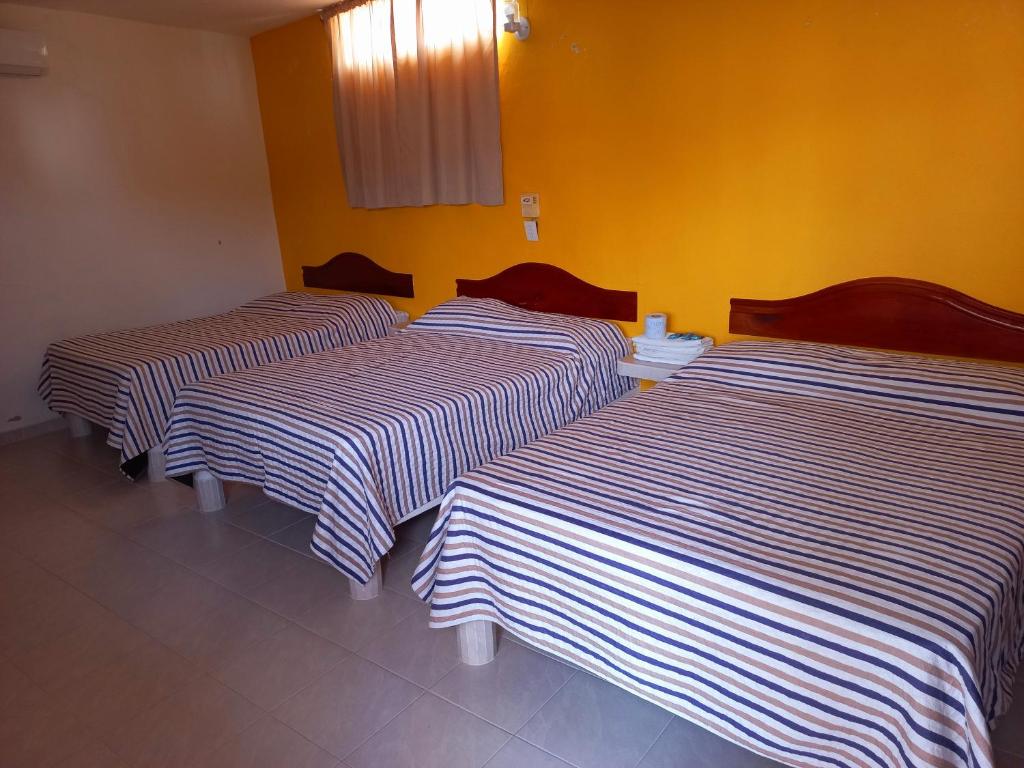 Postel nebo postele na pokoji v ubytování Posada Casa Bugambilias