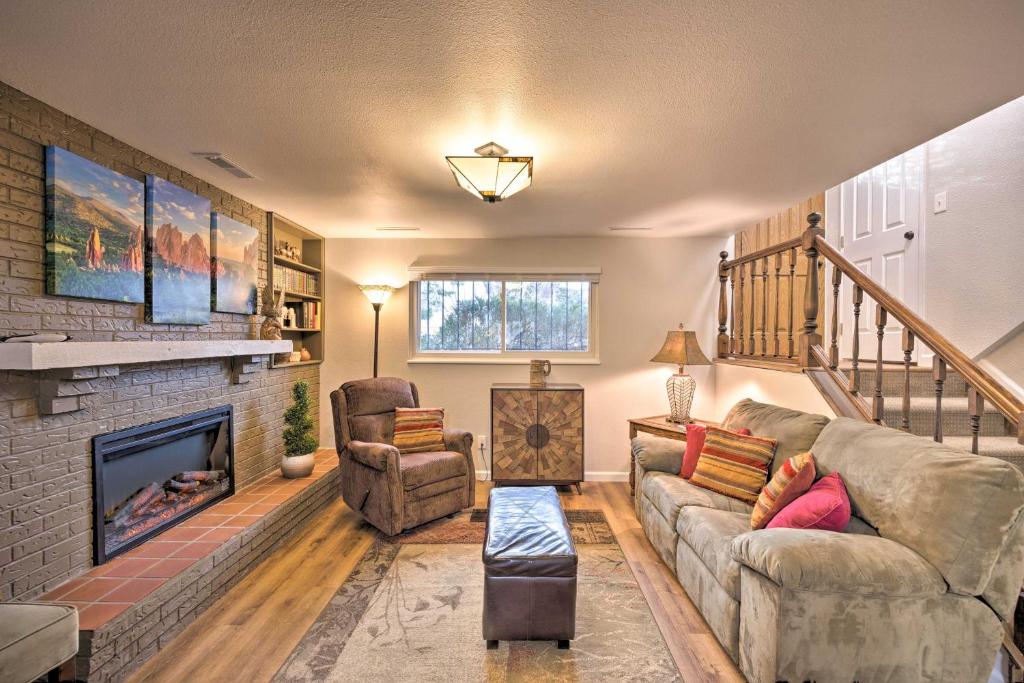 a living room with a couch and a fireplace at Hillside Place with Mountain Views about 8 Mi to Dtwn! in Colorado Springs