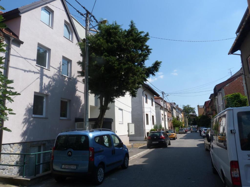 a blue car parked on the side of a street at Apartments Luxe Self Check in in Zagreb