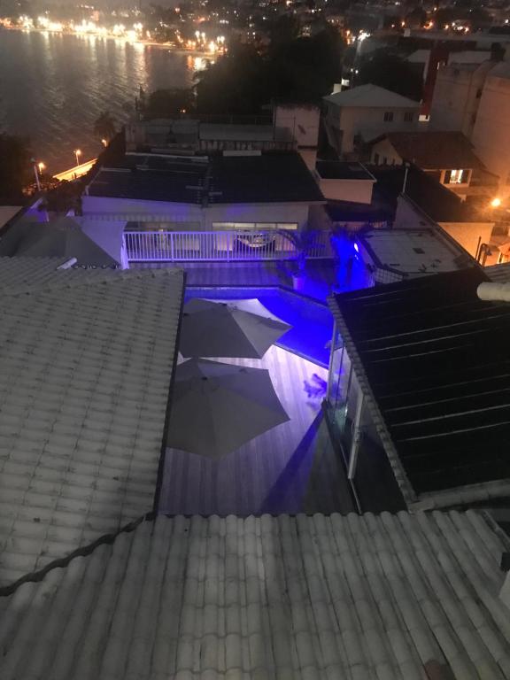 a night view of a swimming pool with blue lights at Hotel Pousada Irmaos Freyhardt in Rio de Janeiro