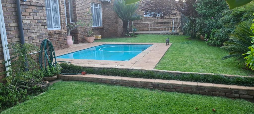 a swimming pool in the backyard of a house at Hornbill Helipad 1 in Centurion