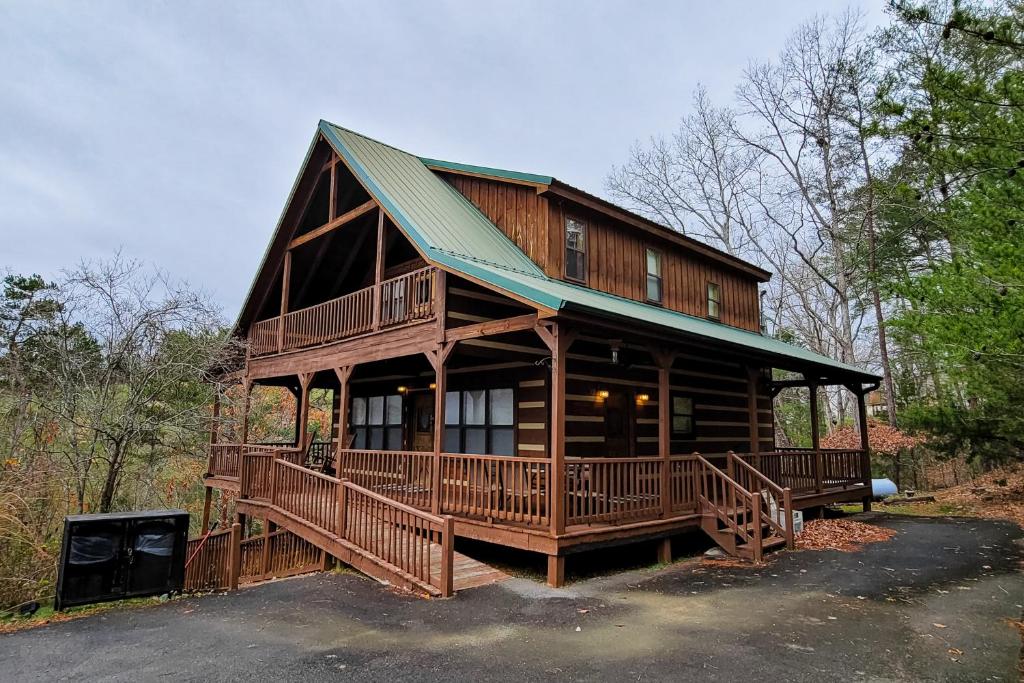 a large wooden cabin with a large deck at Autumns Peak in Sevierville
