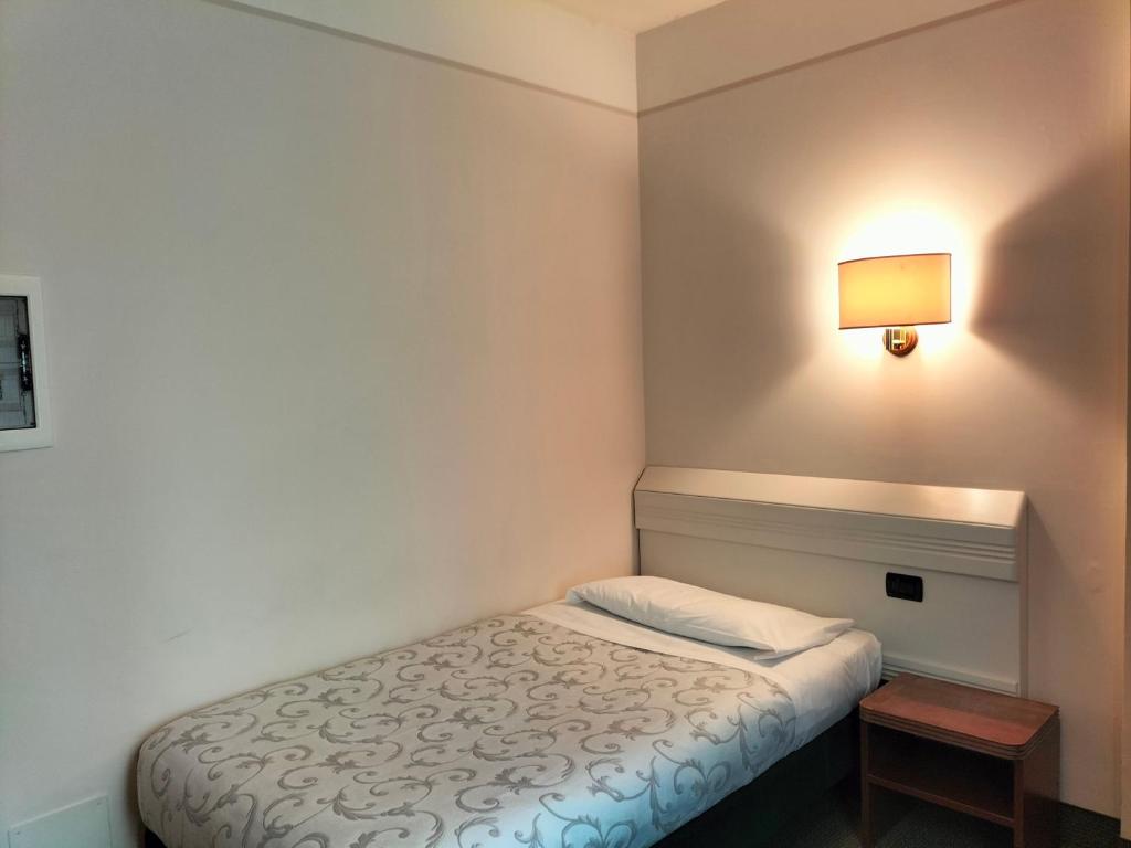 Posteľ alebo postele v izbe v ubytovaní Hotel Arcadia