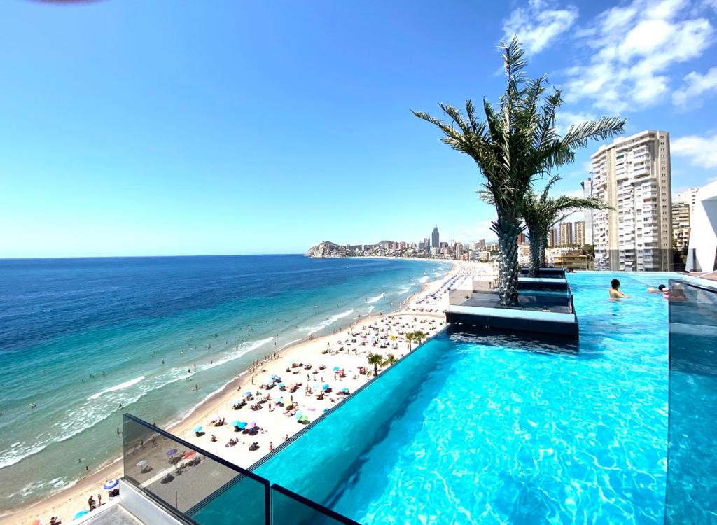 a view of a beach and a swimming pool at Exclusive Apartments on the first line of Benidorm Mar y Sol in Benidorm