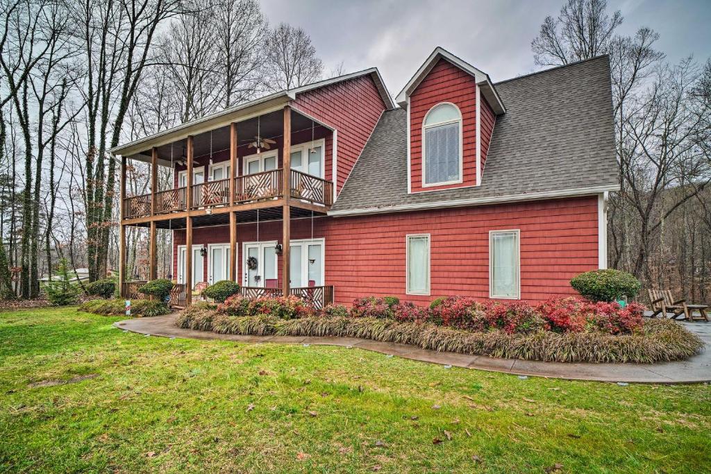 a red house with a balcony on a yard at Dog-Friendly Family Home Steps to Norris Lake in Maynardville