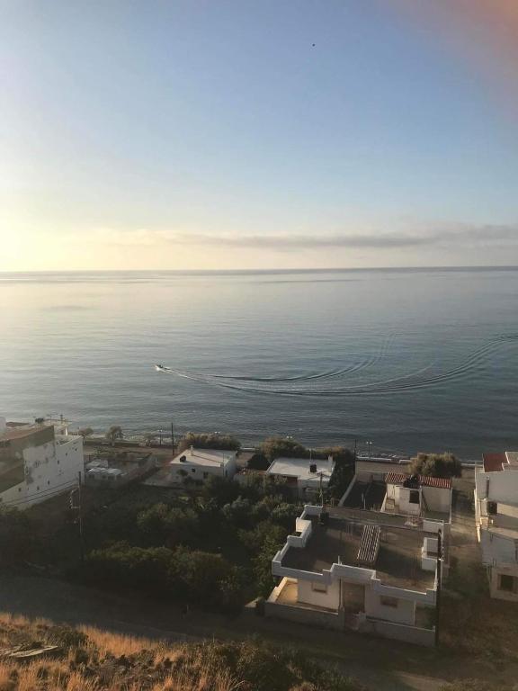 an aerial view of the ocean and buildings at Minoan house in Tsoutsouros