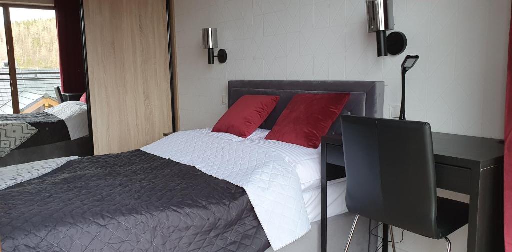 Posteľ alebo postele v izbe v ubytovaní Karpatia Resort Apartament Krystallos