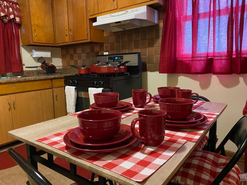 a kitchen table with red cups and plates on it at Nice 3 Bdr FREE Wine, Wi-fi and Parking in Milwaukee