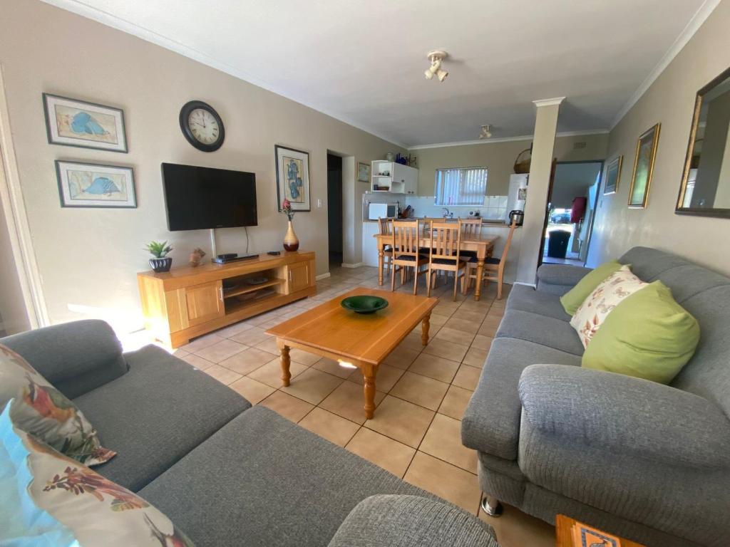 a living room with a couch and a table at Goose Valley Unit EE4 in Plettenberg Bay