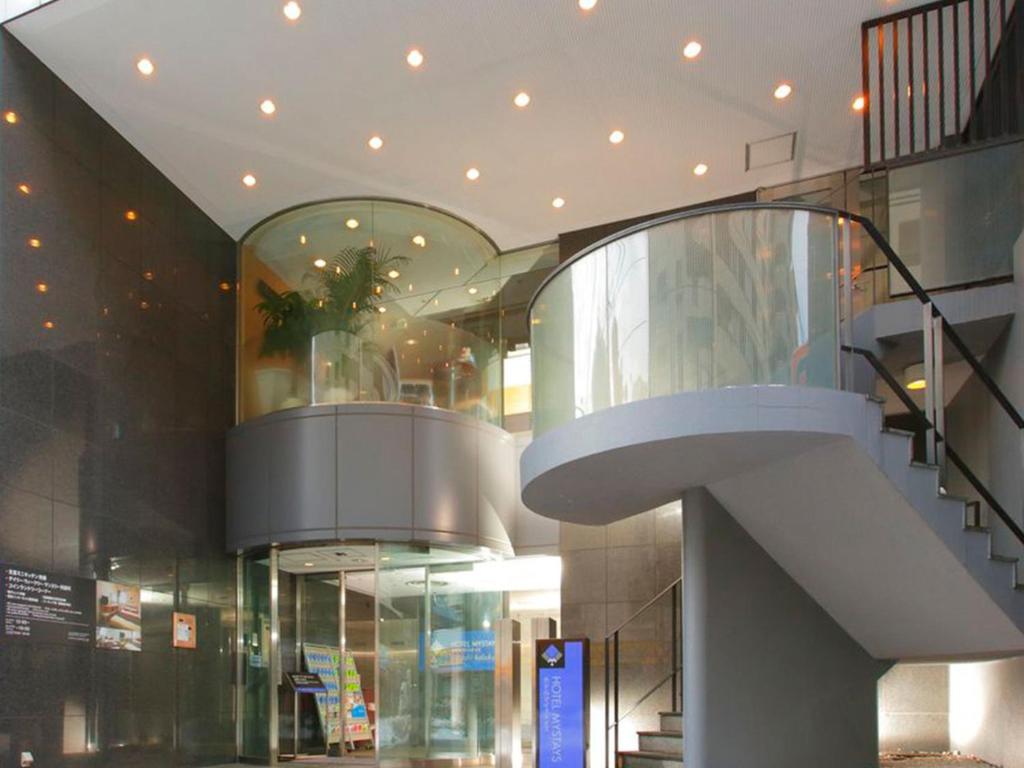 a building with a spiral staircase in a mall at HOTEL MYSTAYS Higashi Ikebukuro in Tokyo