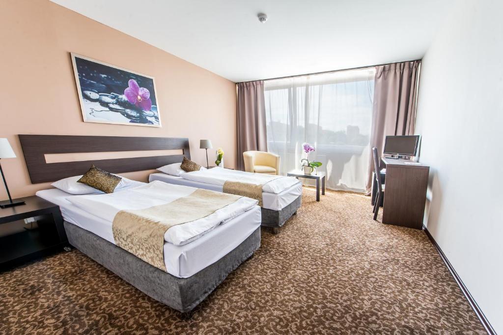 Postel nebo postele na pokoji v ubytování Hotel Cascade