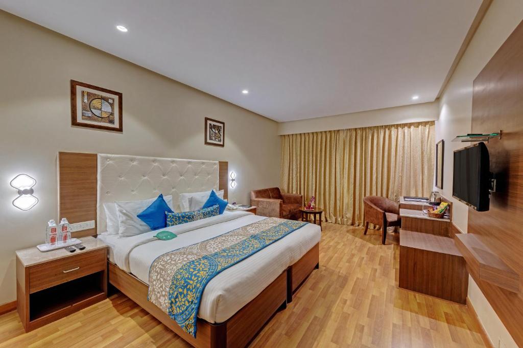 a hotel room with a bed and a television at Click Hotel Caliph, Mumbai in Mumbai