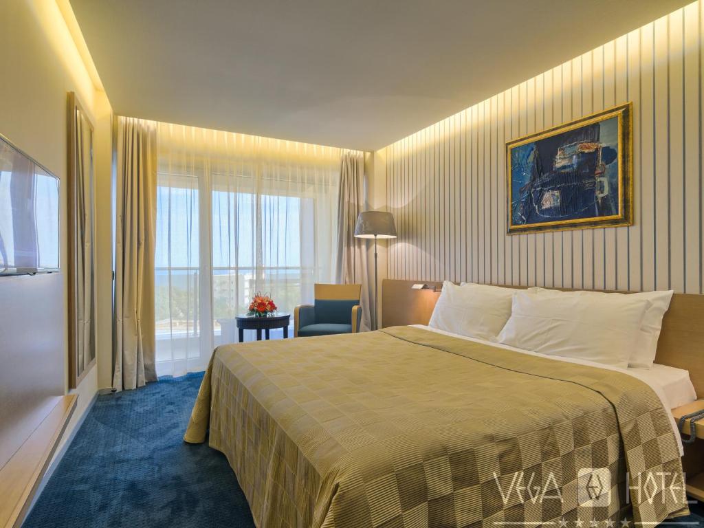 Postel nebo postele na pokoji v ubytování Vega Hotel