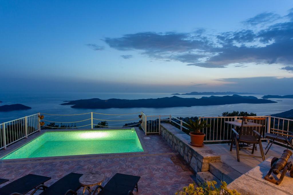 a swimming pool with a view of the ocean at Village house Ana Dubravica in Dubravica