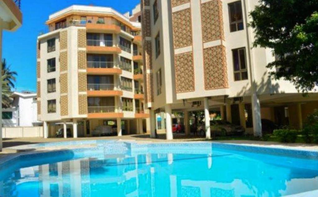 a large swimming pool in front of a building at SeaOne Nyali Mombasa Private Studio w/ pool in Mombasa