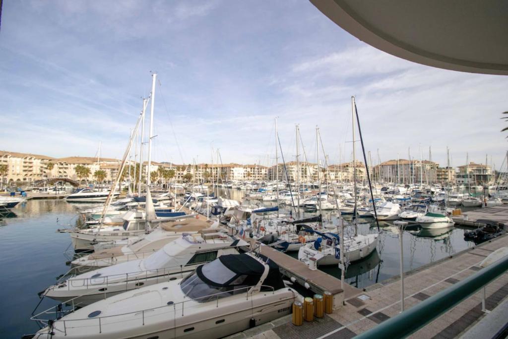Une bande de bateaux amarrés dans un port de plaisance dans l'établissement Apartment With Balcony And View On The Port, à Fréjus