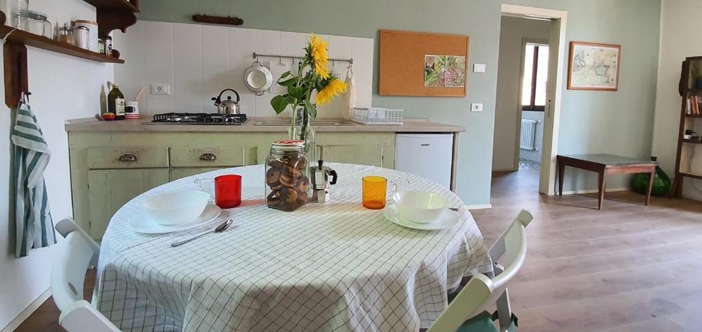 a kitchen with a table with a vase of flowers on it at Appartamento Montebello in Rovato