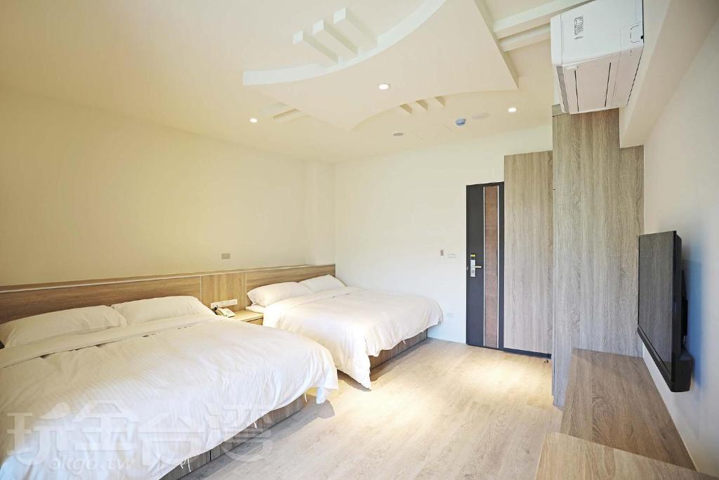 Postel nebo postele na pokoji v ubytování Riyuewan Homestay