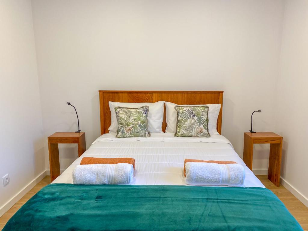 a bedroom with a large bed with two night stands at Baía dos Moinhos in Ribeira Grande