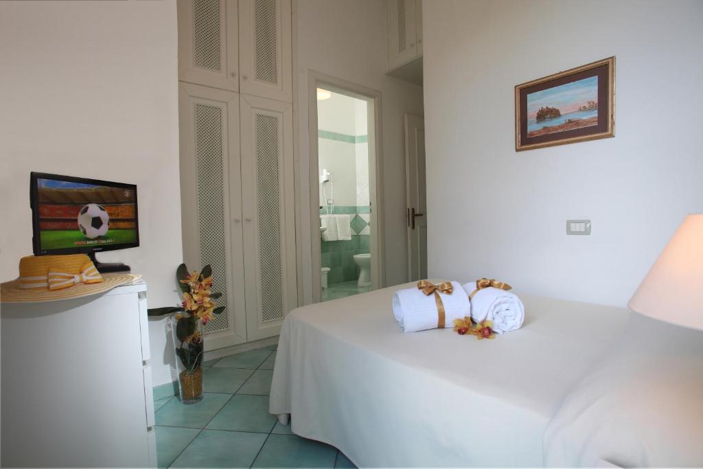 Postel nebo postele na pokoji v ubytování Hotel & Residence Matarese