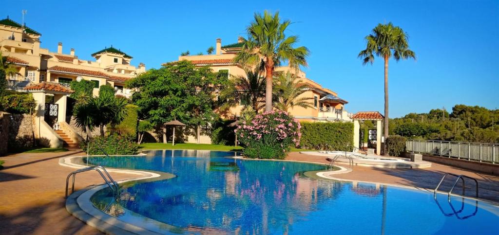 a large swimming pool in front of a building at Piso Mirador Ses Cales 61 Calas de Mallorca in Calas de Mallorca