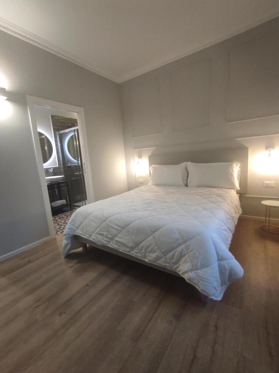 1 dormitorio con 1 cama blanca grande y 2 lámparas en Residenza Montebello, en Ancona