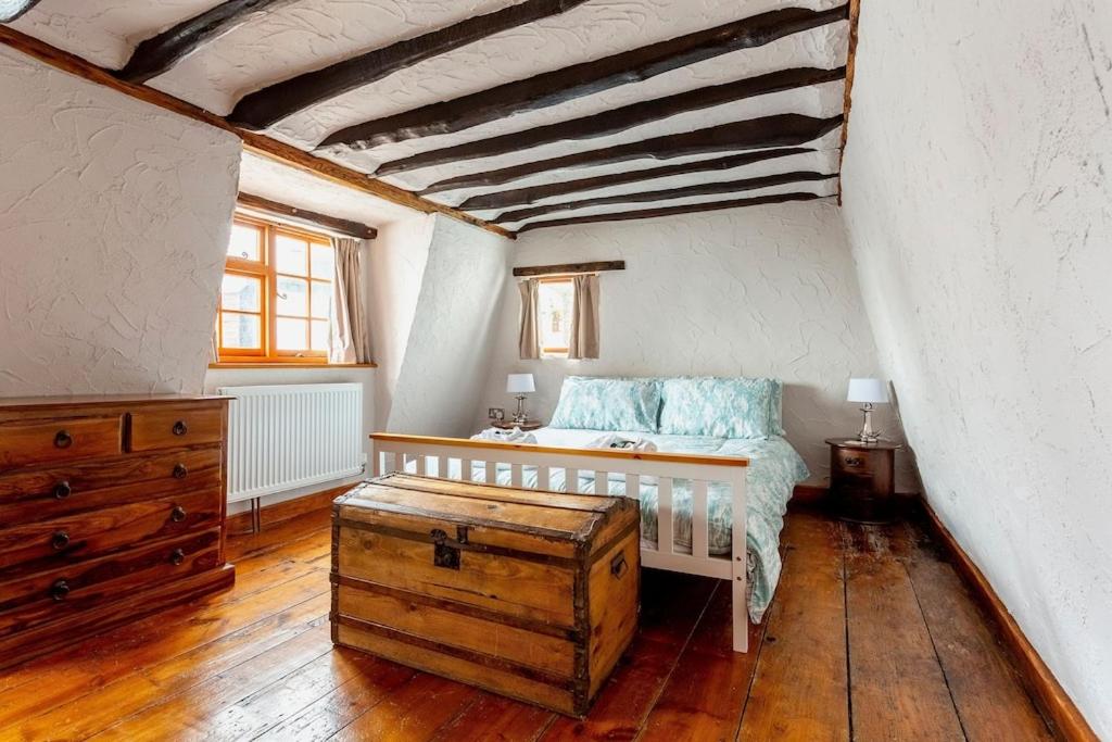 a bedroom with a bed and a wooden floor at Bay Cottage in Broadstairs - Winter special offers! in Broadstairs