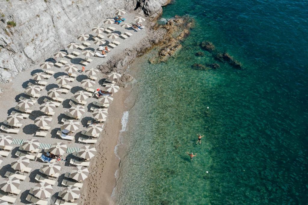 an overhead view of a beach with umbrellas and the ocean at Hotel Cetus in Cetara
