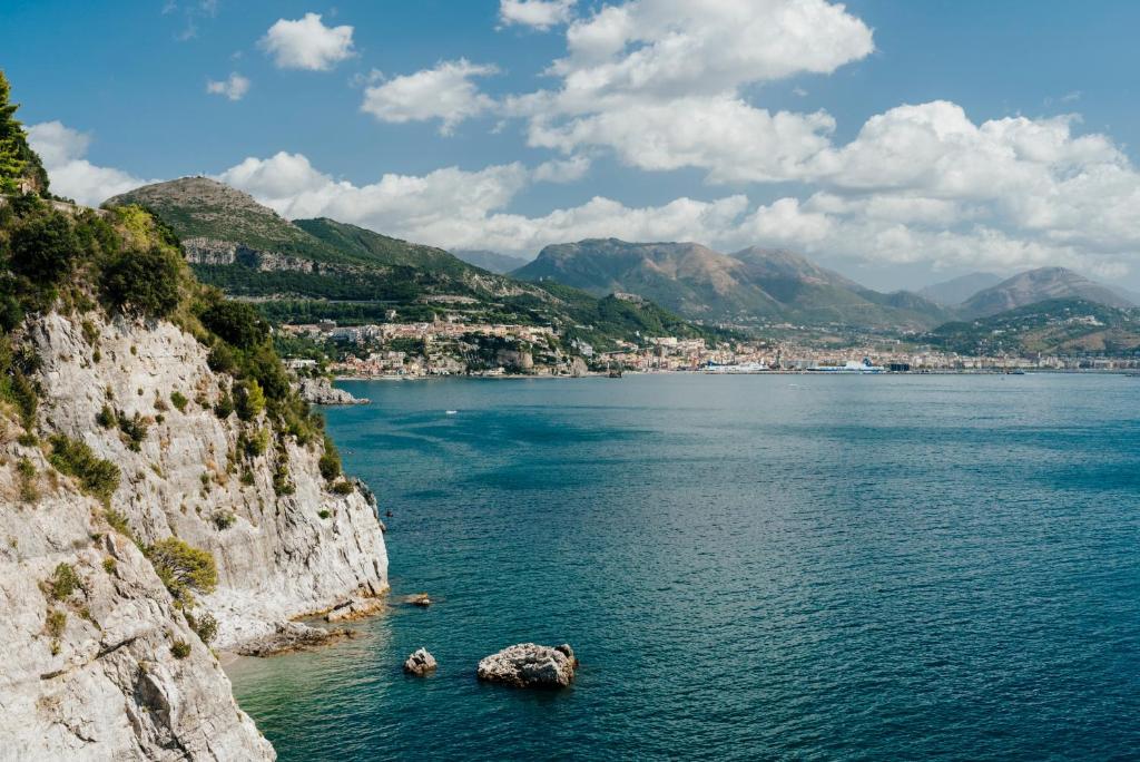 a view of a large body of water with mountains at Hotel Cetus in Cetara