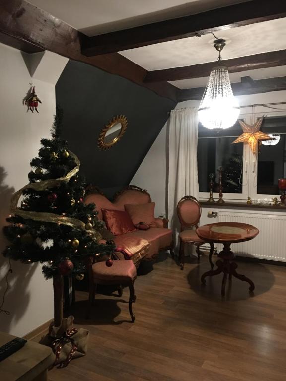 a living room with a christmas tree and a couch at Apartament u Skwarka in Poronin