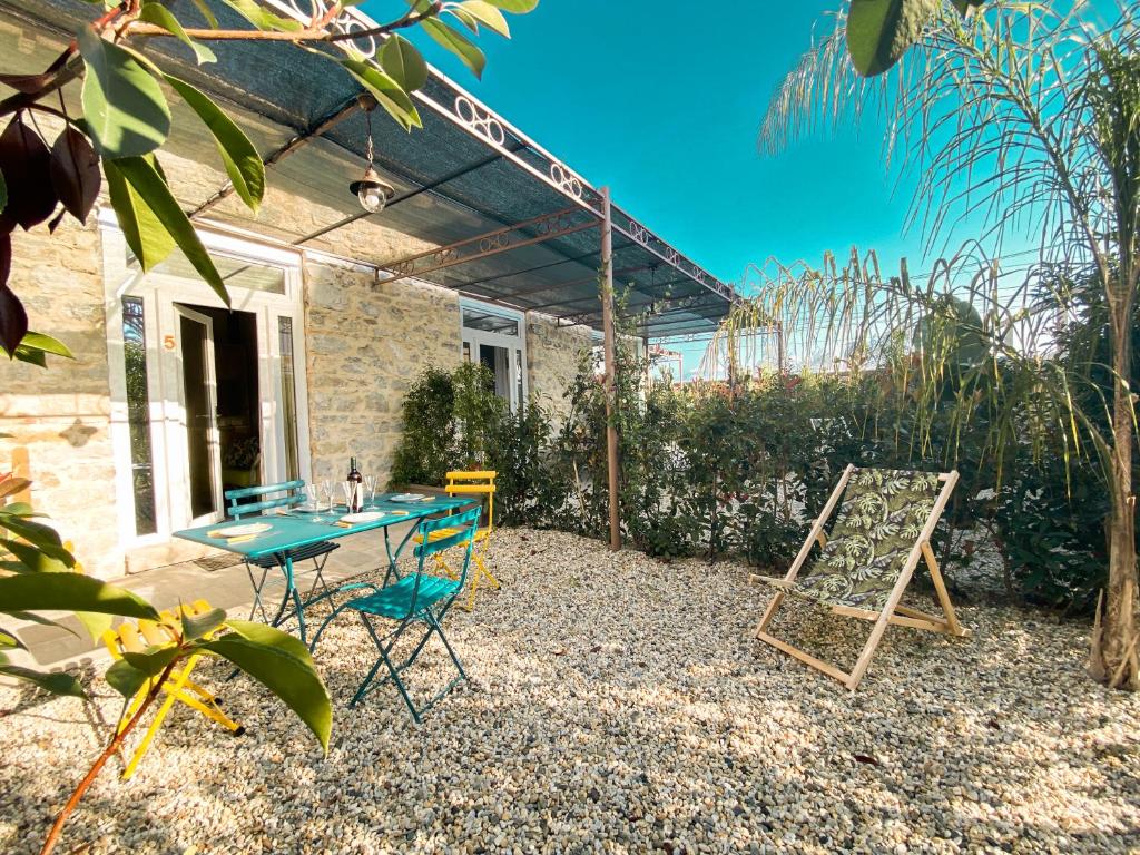 eine Terrasse mit einem Tisch und Stühlen vor einem Haus in der Unterkunft New Agriloft 5 Marina Wi-Fi, Clima, Giardino, mare a 50 mt in Bordighera